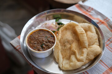 Close up shot of chole bhature, famous street food in Delhi India. traditional North Indian main course