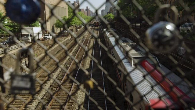 New York City Subway Train Passing Under Camera Seen Through Fence On Manhattan's Upper East Side