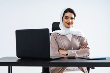 Beautiful arab middle-eastern corporate businesswoman with traditional abaya dress working in the...