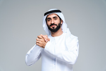 Handsome arab middle-eastern man with traditional kandora portrait in studio