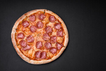 Tasty fresh pizza with salami, cheese, tomatoes, spices and salt