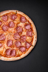 Tasty fresh pizza with salami, cheese, tomatoes, spices and salt