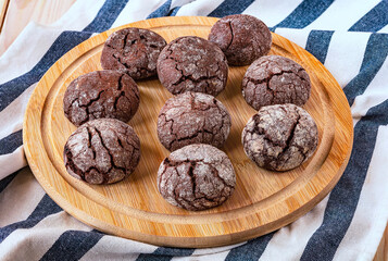 Freshly baked chocolate chip cookies on a wooden tray. Chocolate pastry, top view.