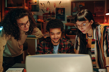 Group of young people developing new computer program, they watching presentation on computer