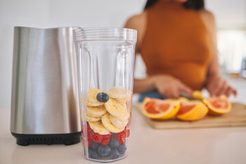 Fruit, smoothie and closeup with woman and blender in kitchen for gut health, diet and breakfast. Wellness, detox and nutrition with female person at home for cooking, juice and weight loss milkshake