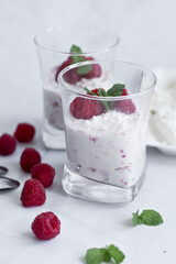Yogurt and raspberry dessert. Deliciously. On a white background