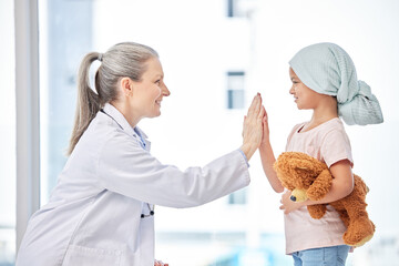 Cancer, child and doctor high five in support, healthcare service and success or empathy, love and...