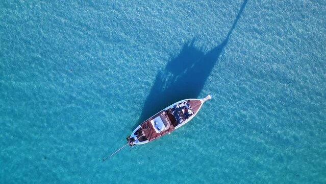 shadow Luxurious boad in crystal clear water. Magic aerial top view flight drone