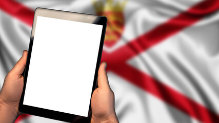 Man hold tablet phone pc gadget with white blank screen, copy space for text, image or message. Flag of Jersey country on background. Technology, information, business
