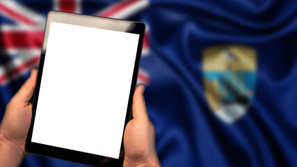 Man hold tablet phone pc gadget with white blank screen, copy space for text, image or message. Flag of Saint Helena, Ascension and Tristan da Cunha country on background. Technology, information, bus