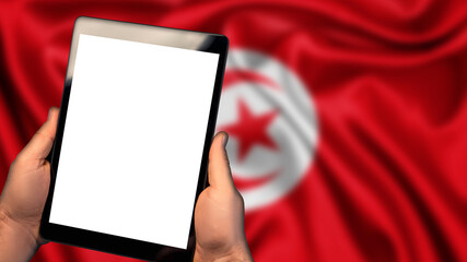 Man hold tablet phone pc gadget with white blank screen, copy space for text, image or message. Flag of Tunisia country on background. Technology, information, business


