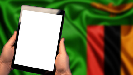 Man hold tablet phone pc gadget with white blank screen, copy space for text, image or message. Flag of Zambia country on background. Technology, information, business
