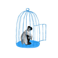 Young guy sitting into imagination bird cage. Fear of social pressure and opinion. Self-limits....