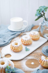 A cup of milk and handmade muffins. Baking with sugar