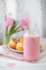 Strawberry milkshake, cakes and pink hyacinths