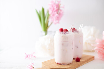 Two glasses with a cocktail of pink color with glass tubes