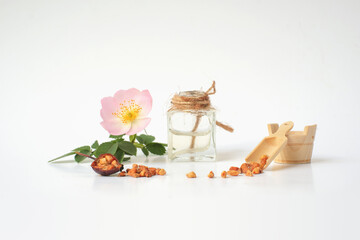 Rosehip seed, rosehip flower, small wooden cooking utensils, rosehip seed oil