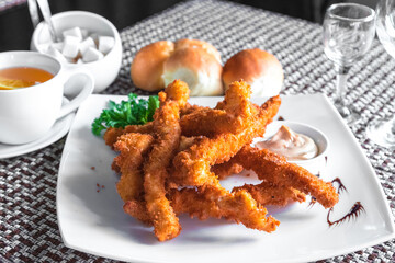 Crispy fried chicken fillet or chicken stripes with sauce