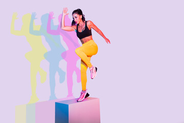 Sportive woman training on a colorful background - Athletic fit adult female doing functional...