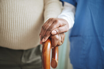 Cane, senior patient and nurse holding hands for support, healthcare and kindness at nursing home. Elderly person and caregiver together for homecare, rehabilitation or help for health in retirement