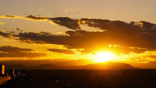 Time lapse of dramatic sunset sky over desert highway in California, USA