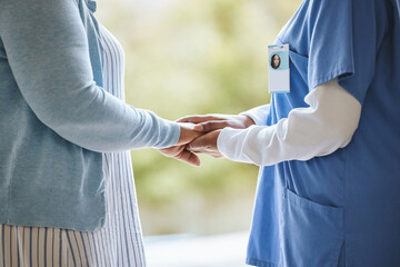 Woman patient, nurse and holding hands for support, healthcare and kindness at nursing home. Senior...