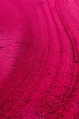 Surreal background of red, viva magenta streaks in the sand. Texture. 