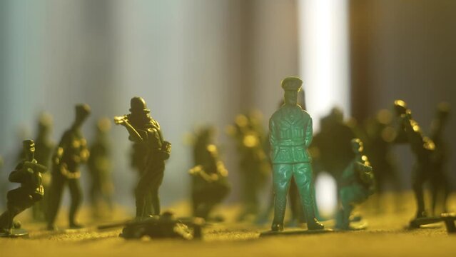 Toy soldiers standing on battlefield shoulder to shoulder under leadership of army general. Violence war resistance and peace without armored invasion