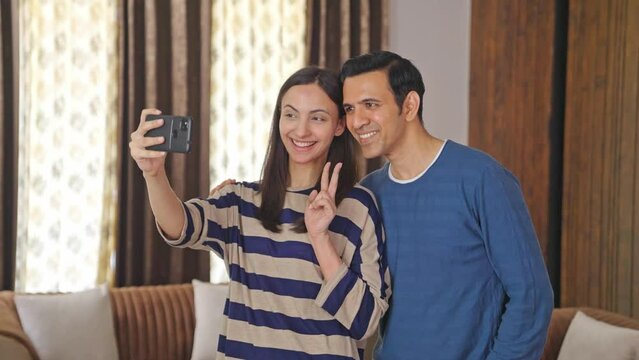 Happy Indian couple clicking good selfies