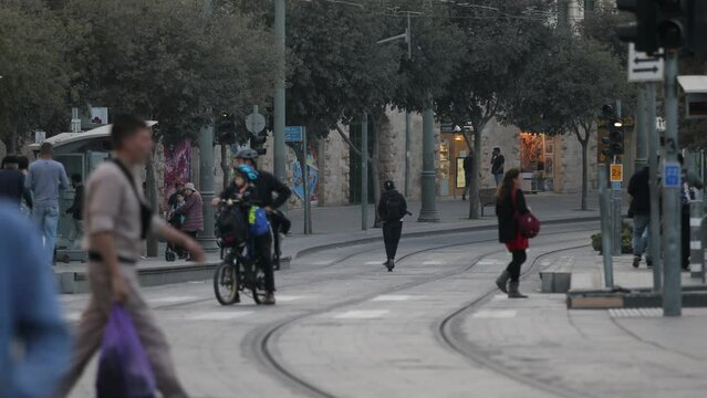 people crossing metro line in jerusalem israel