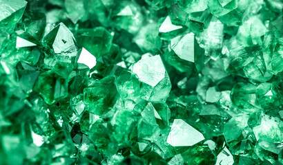 Green crystal mineral stone. Gems. Mineral crystals in the natural environment. Texture of precious and semiprecious stones. Seamless background with copy space colored shiny surface of precious stone