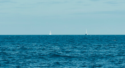 in the middle of the sea with an infinite ocean with a perfect blue sky