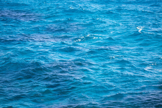 Water Background, Turquoise Shallow Sea Water. Beautiful Texture Of Sun Glare On The Water.