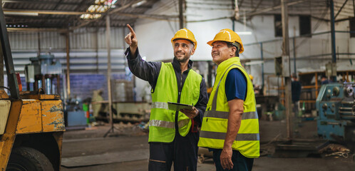two engineer look projects and planning with tablet mobile in factory