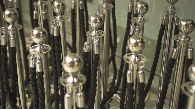 Many barier poles in metal with ropes