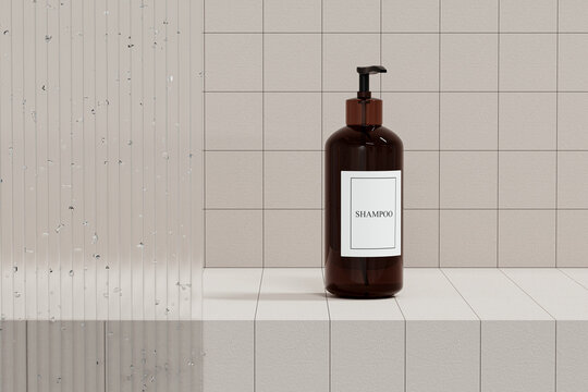 Amber pump bottle with white label mockup for bathing products in bathroom. Blurred foreground of glass panel with water drops. Beige tiles background. Brown glass jar hand lotion or hair shampoo