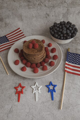 Pancakes with forest fruits berries on beautiful table. Healthy breakfast. Blueberries, raspberries on pancakes. Independence Day 4th of July.