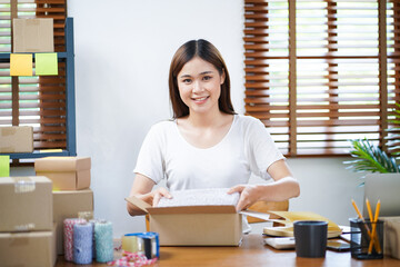 Business From Home Asian woman preparing package delivery box Shipping for shopping online. young start up small business owner at home online order