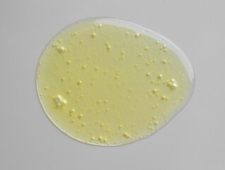 Spilled fresh olive oil on gray background