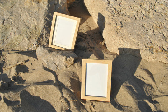 Vertical Wooden frame mockup on summer beach. Ocean vibe. Shell and sand, vacation interior.