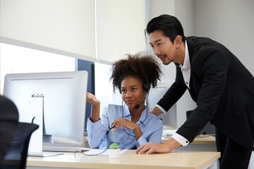 businessman or supervisor training and suggesting about work to colleagues at call center service in the office