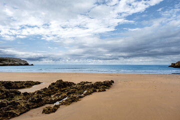 Fototapeta na wymiar Beautiful and quiet sandy beach in the Cantabrian Coast