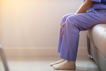 A female doctor is sitting alone in the doctor office after being exhausted from treating a...