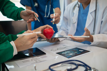 concept of medical team meeting to discuss about treating heart disease with surgery and preventing...