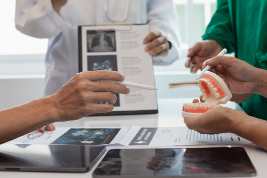 team of dentists is diagnosing inside conference room treating patient toothache. team of doctors and dentists are meeting to find a way to treat root canals that cause pain due to inflammation.