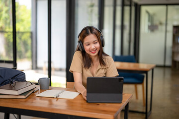 Happy female student focus on studying online on laptop, typing on laptop. Remote education and e-learning, Video call and research.