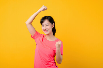 Portrait beautiful young asian sports fitness woman happy smile wearing pink sportswear posing exercise training workout isolated on yellow studio background. wellbeing and healthy lifestyle concept.