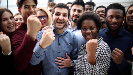 Confident diverse college students show fist up.