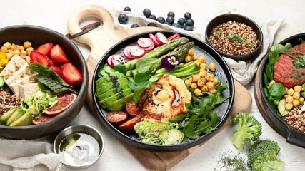Healthy vegetarian and vegan  salads and Buddha Bowls with vitamins, antioxidants, protein on light  background.