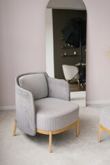 Classic modern armchairs in gray color in the interior of the living room